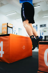 an athlete doing ACL reconstruction rehabilitation by box jump in sportential training studio