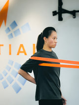 a female athlete doing injury prevention  training for shoulder with resistance band in sportential training studio