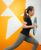 a female doing lunge exercise training for health in sportential training studio and clinic