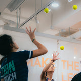 two female athletes doing eye-hand coordination training in sportential training studio and clinic