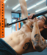 a muscular athlete doing single arm inverted row in sportential training studio and clinic