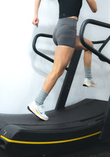 an athlete doing rehab on the woodway for running mechanics correction