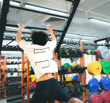 a climber is doing jump pull up in sportential training studio and clinic